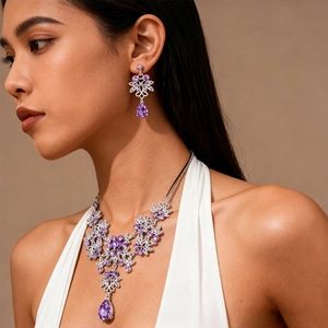 Macro view of silver flower necklace with purple water drop zircons and matching earrings