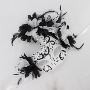 Detail of Day of the Dead mask with black and white feathers, lace flowers and rhinestones