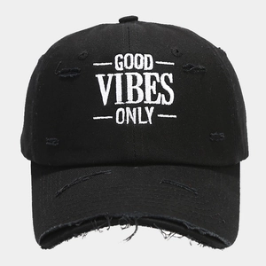 Detail of distressed black cotton baseball cap with white Good Vibes Only embroidery
