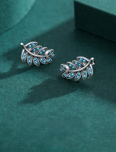 Macro shot of S925 sterling silver leaf earrings with vintage turquoise stone inlay