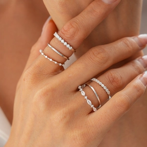 Detail of 6-piece silver stacking ring set with round and marquise zircon on hand