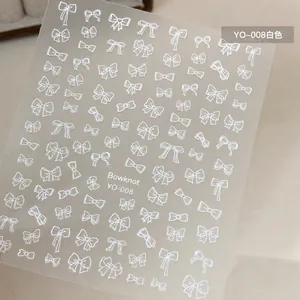 Detailed view of white bowknot nail art stickers featuring variety of elegant ribbon designs