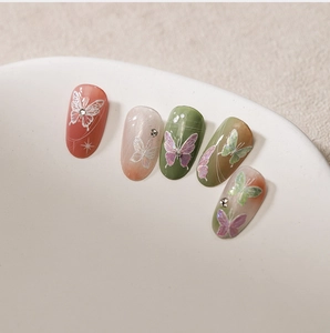 Detailed close-up of 5D stereoscopic butterfly nail art stickers with delicate rhinestones