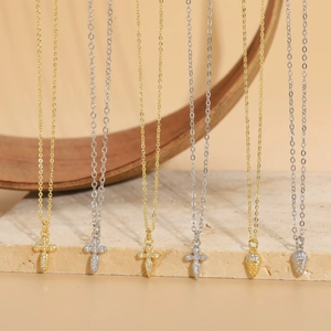 Cross and acorn pendants with zircons on gold and silver plated chains for women