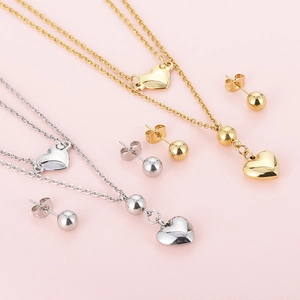 Minimalist double-layered gold and silver necklace set with heart and bead pendants