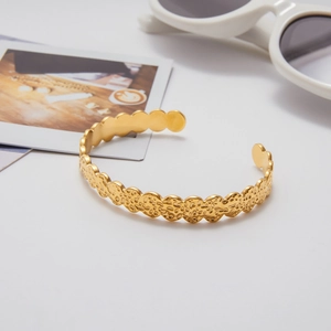 Detail shot of 18k gold plated stainless steel cuff bracelet with hammer-textured finish