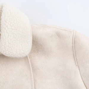 Close-up of the beige suede jacket showing soft faux fur collar and shoulder stitching