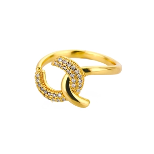 Macro view of gold-plated layered interlaced ring with shimmering pave white cubic zirconia