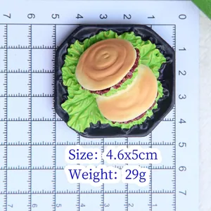 Miniature burger magnet model 4.6x5cm shown on measurement mat for detailed size view