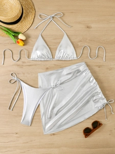 Detailed flat lay of a silver metallic 3-piece bikini set with a drawstring skirt