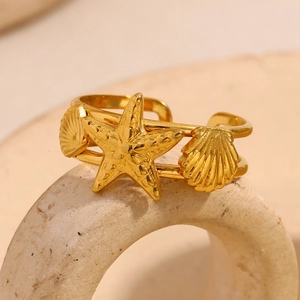 Detail of 18K gold-plated starfish and seashell open ring with a double-band design