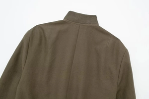 Macro shot of ribbed stand collar and back seam details on the khaki flight jacket