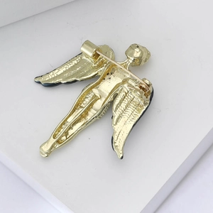 Detailed back view of a golden angel brooch showing the pin mechanism and wing texture