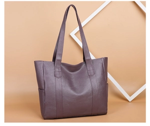 Detailed view of dark grey PU leather tote bag with sturdy handles and textured surface