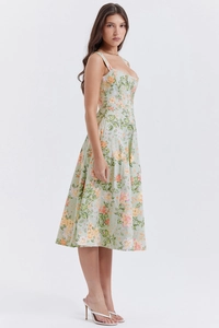 Detail of light green floral midi dress with side slit and waist-slimming silhouette