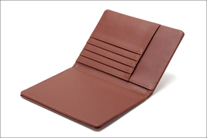 Detail of open brown leather RFID passport wallet with 4 card slots and travel pockets