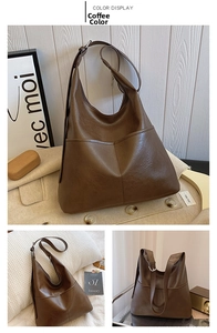 Detail of soft brown leather hobo tote showing adjustable silver buckle and stitching