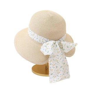 Straw sun hat with floral ribbon bow and wide brim for women in pastoral style