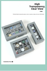 Cajas de relojes en cuero gris con tapas de vidrio y cierres metálicos varios tamaños