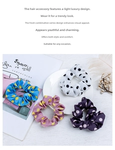 Polka dot satin scrunchies in blue, purple, and white displayed on a textured surface