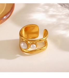 Close-up of gold stainless steel open ring with two asymmetrical inlaid pearls