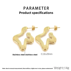 Macro shot of gold irregular wave pattern earrings in brushed stainless steel finish