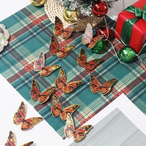 Detailed view of red and gold snowflake butterfly wall stickers with Christmas decorations