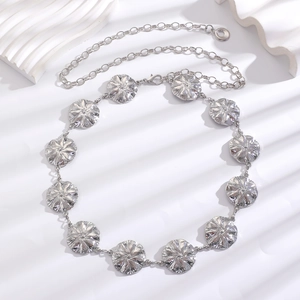 Detail view of silver bohemian waist chain with retro floral metal discs and lobster clasp