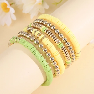 Detail of bohemian multilayer beaded bracelets with yellow and green clay discs
