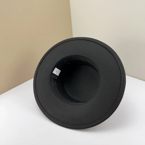 Detailed view of black felt jazz hat interior with material care label and size 58