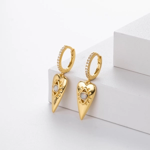 Detail of gold heart earrings featuring opal devil's eye design and zircon pave