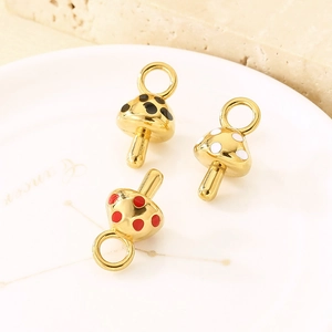 Golden mushroom pendants in red, white and black enamel for DIY necklace making