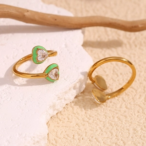 Detail of 18K gold plated heart ring with green enamel and sparkling zircon accents