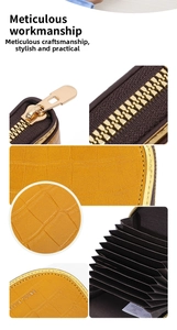 Detail view of yellow faux crocodile wallet featuring gold zipper and multiple card slots