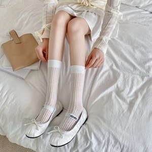 Close-up of white ribbed knee-high socks paired with ballet flats for a JK aesthetic