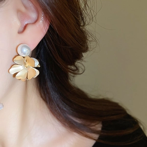 Close-up of vintage flower earrings with freshwater pearls on model for size perspective