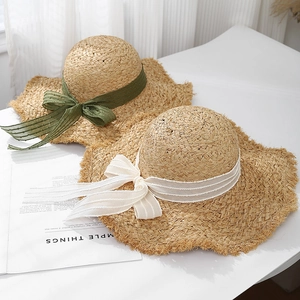 Flat top raffia sun hat with raw edges and silk ribbons for summer beach vacations