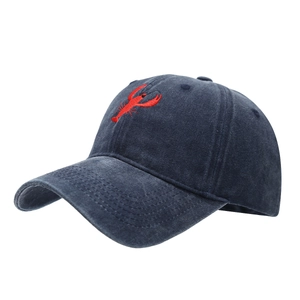 Washed navy cotton baseball cap featuring a detailed red lobster embroidery on front