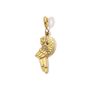 Macro shot of gold parrot pendant with sparkling crystals and metal loop detail