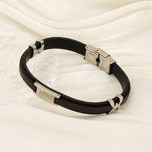 Minimalist stainless steel leather bracelet in black and brown on white silk fabric