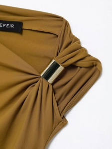 Detailed macro view of ginger knit fabric with elegant gold metal ring buckle ornament