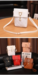 Detailed view of quilted PU leather phone bags with pearl charms in five various colors