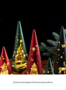Close-up of conical Christmas tree lanterns with gold cut-outs and warm LED light