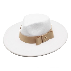 Detail of white wool fedora hat with khaki ribbon and golden bee metal buckle
