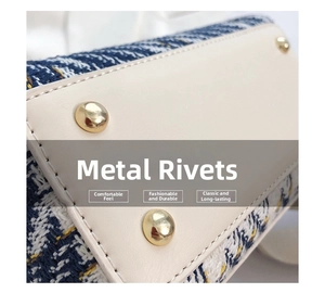 Detail view of tweed handbag bottom with cream leather patch and gold metal rivets