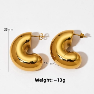 Detail view of bold C-shaped earrings with 35mm height and 14mm width dimensions