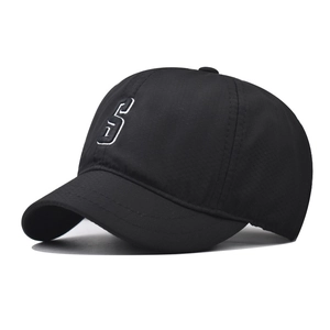 Close-up detail of a black quick-dry cap featuring a white embroidered letter S on the front
