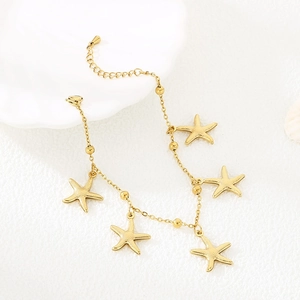 Close-up of gold starfish charms on a delicate stainless steel chain for beach vacation