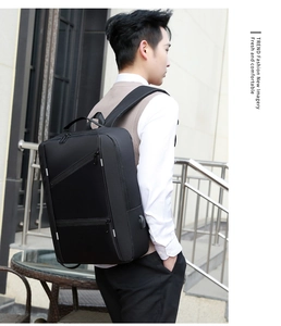Detail of a black business backpack featuring a side USB charging port for travel and work