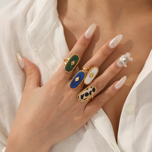 Detail of 18K gold plated stainless steel rings with natural stone and mother of pearl
